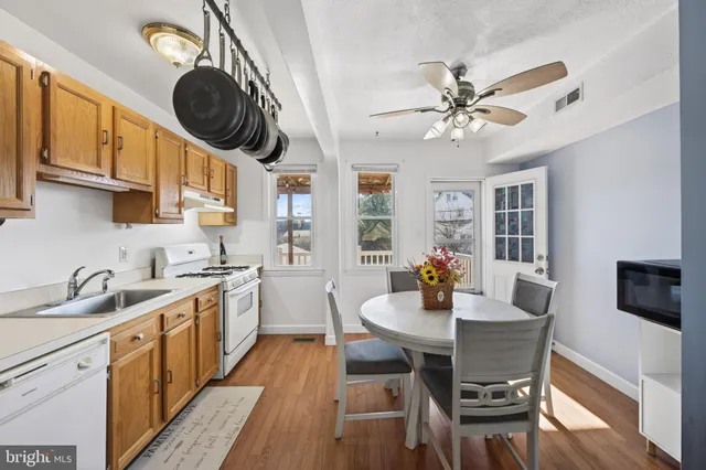 a kitchen with a dining table and chairs