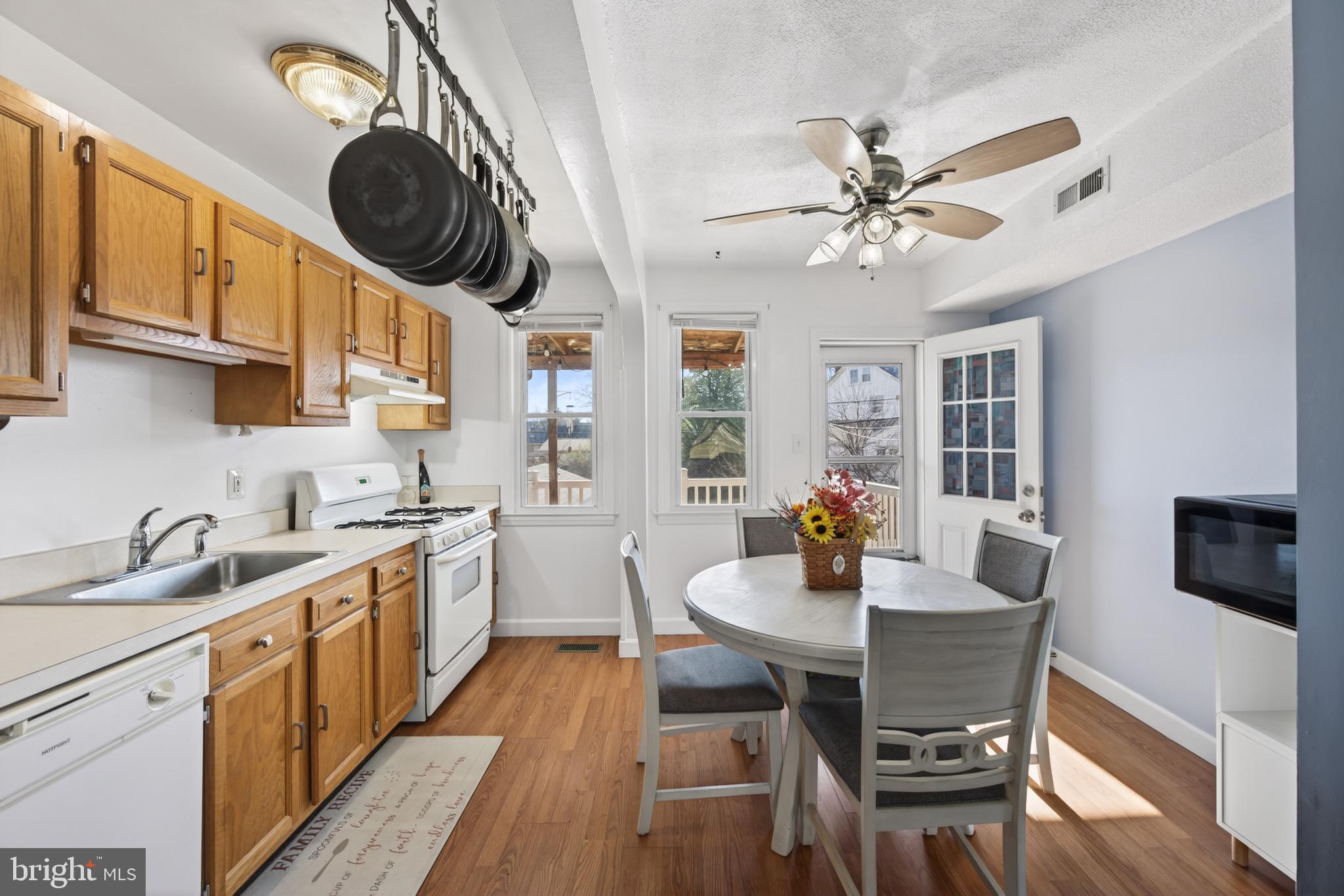 3579 Benzinger Road Baltimore, MD 21229 - Photo 10 of 34 a kitchen with a dining table and chairs