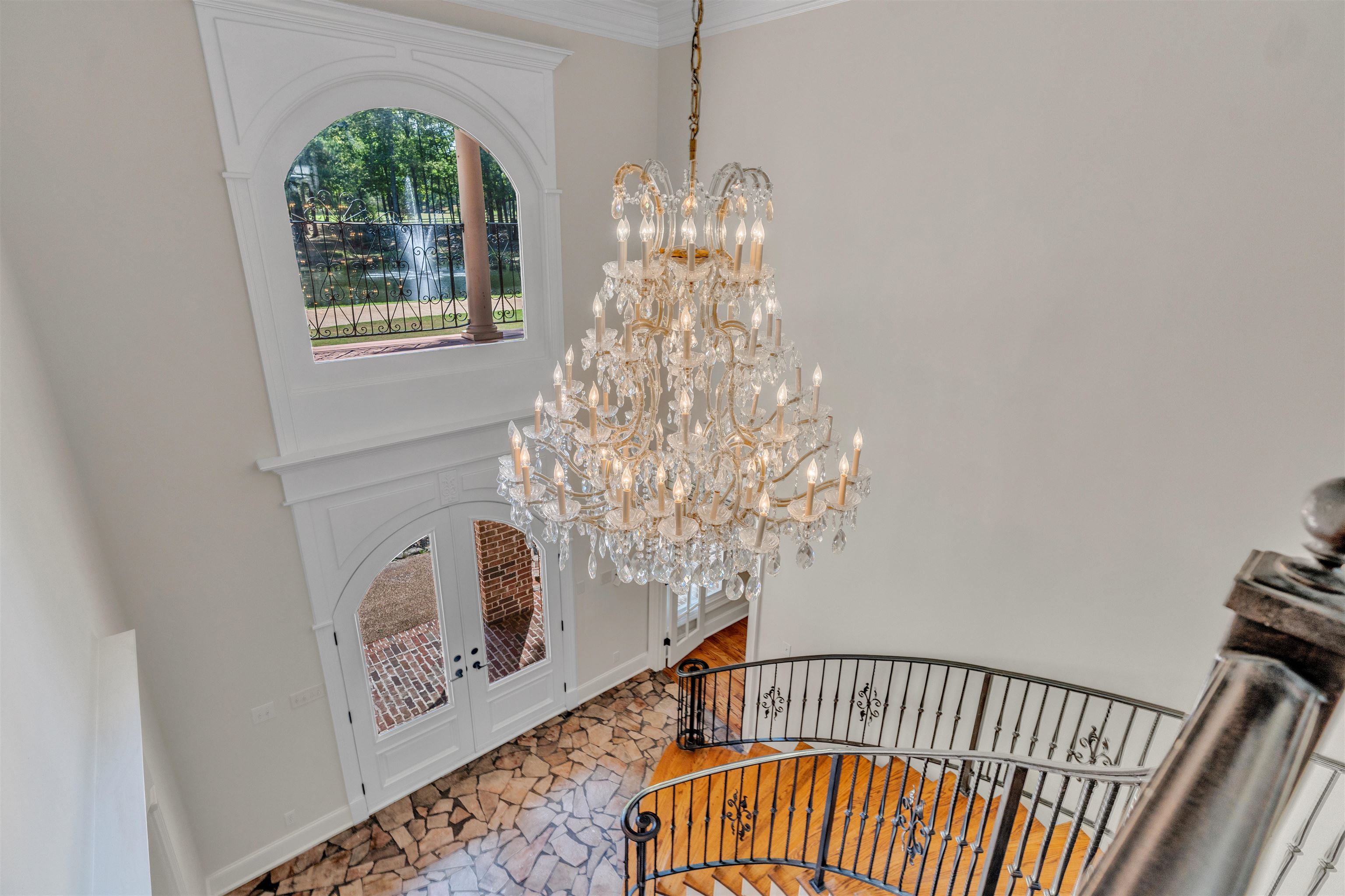 815 Dent Road Eads, TN 38028 - Photo 29 of 40 Foyer entrance with a chandelier, stairs, a high ceiling, french doors, and crown molding