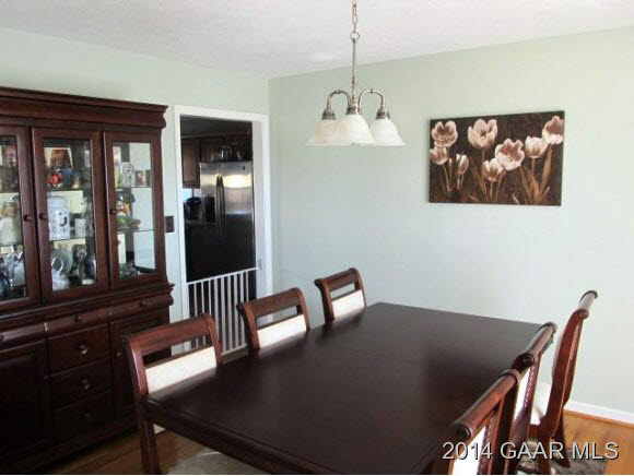 81 Sir Robin Road Waynesboro, VA 22980 - Photo 4 of 25 a view of a dining room with furniture wooden floor and a chandelier