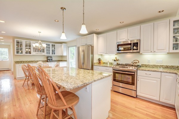 149 Nourse Road Bolton, MA 01740 - Photo 10 of 30 a kitchen with stainless steel appliances granite countertop a stove refrigerator and cabinets