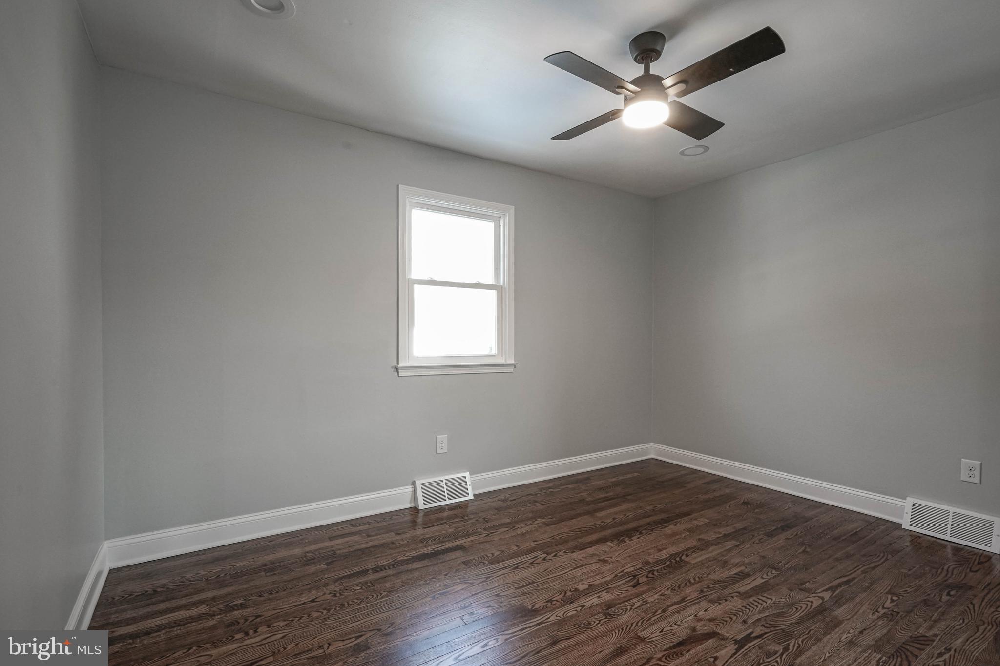 8 Riviera Drive Pennsville, NJ 08070 - Photo 15 of 31 an empty room with wooden floor and windows
