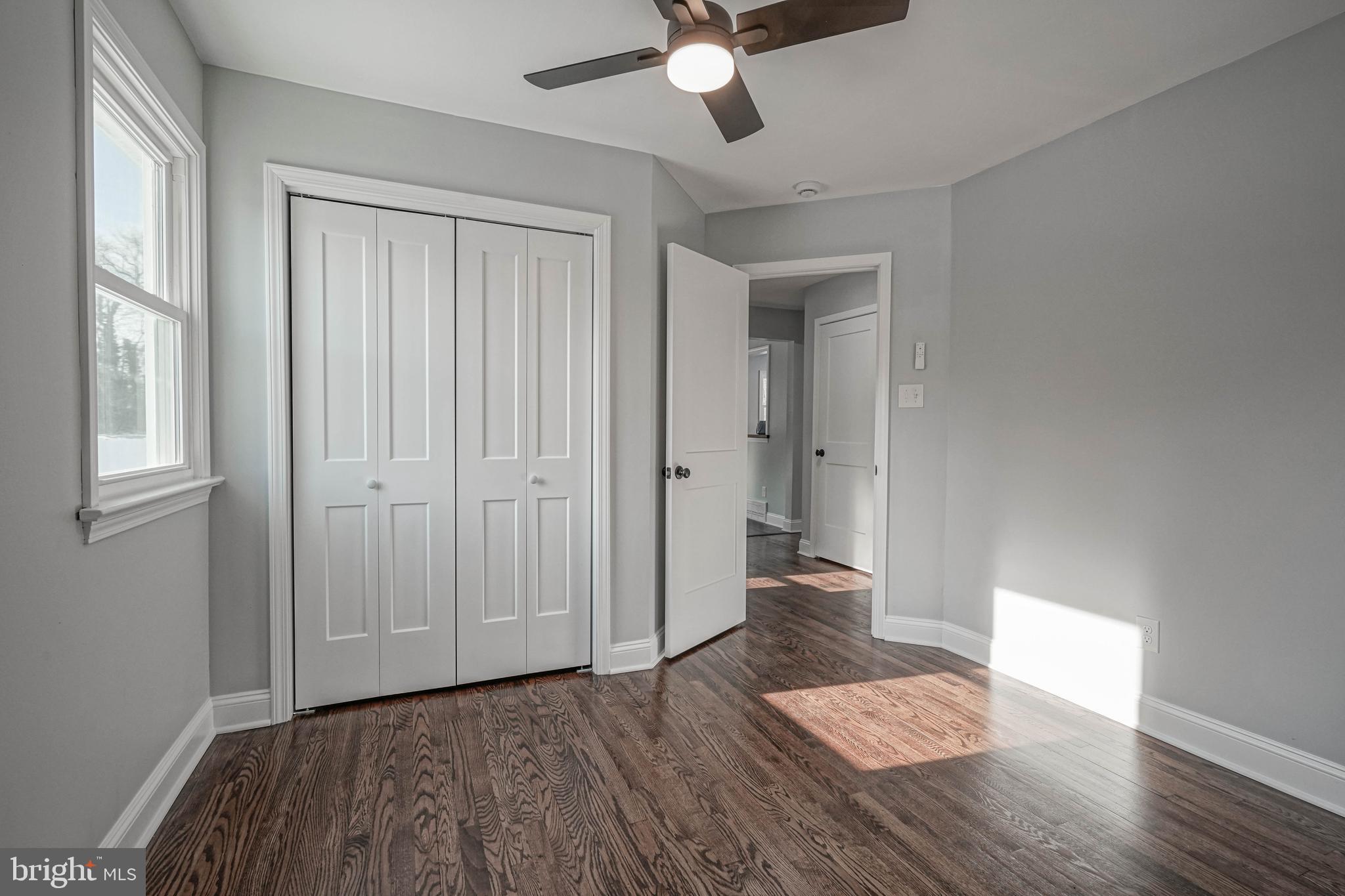 8 Riviera Drive Pennsville, NJ 08070 - Photo 22 of 31 an empty room with wooden floor and a ceiling fan