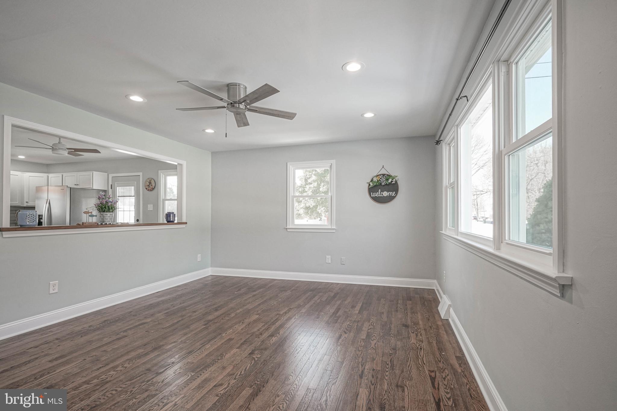 8 Riviera Drive Pennsville, NJ 08070 - Photo 4 of 31 a view of an empty room with wooden floor and a window