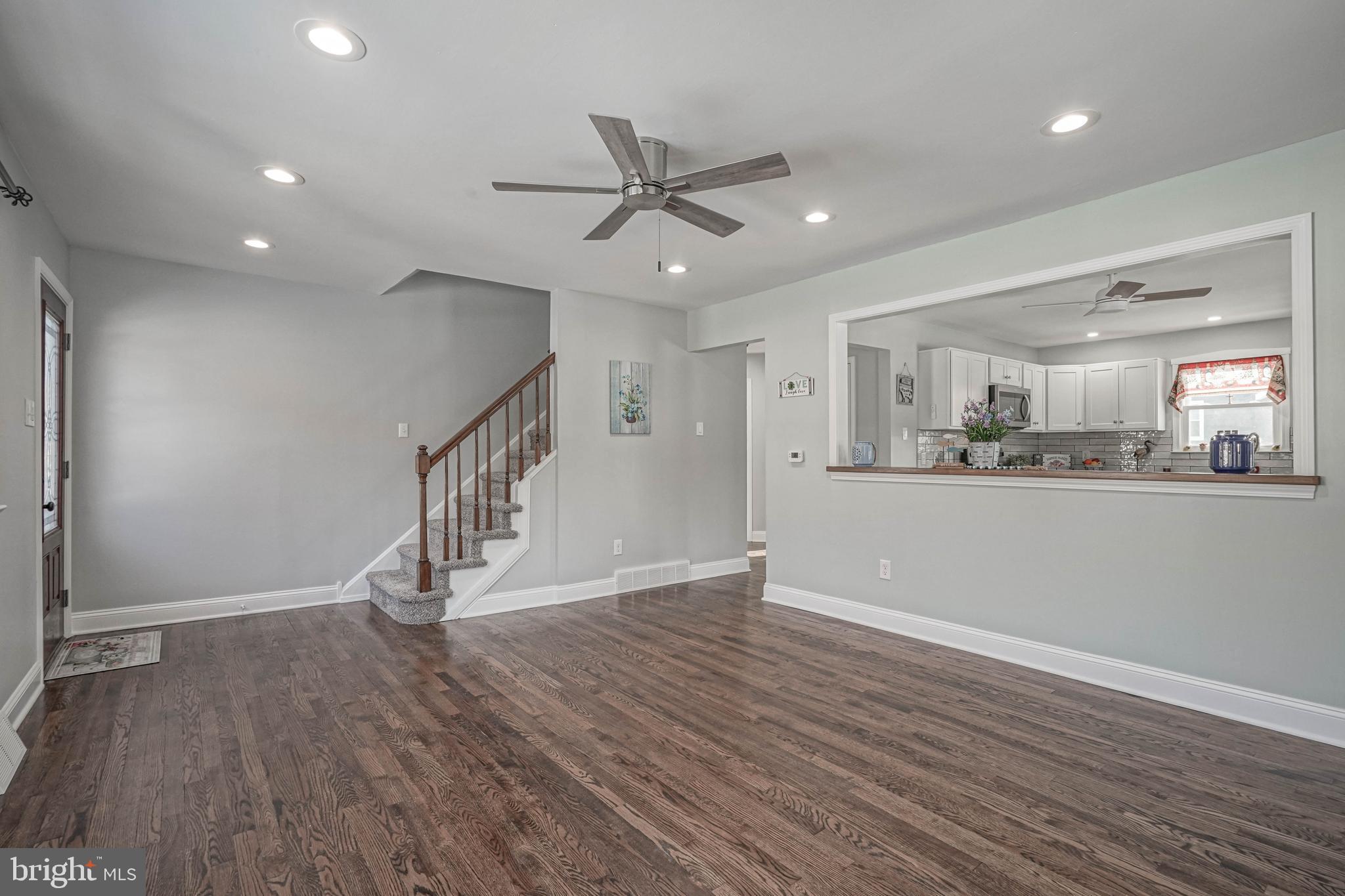 8 Riviera Drive Pennsville, NJ 08070 - Photo 6 of 31 a view of an empty room with wooden floor and a kitchen