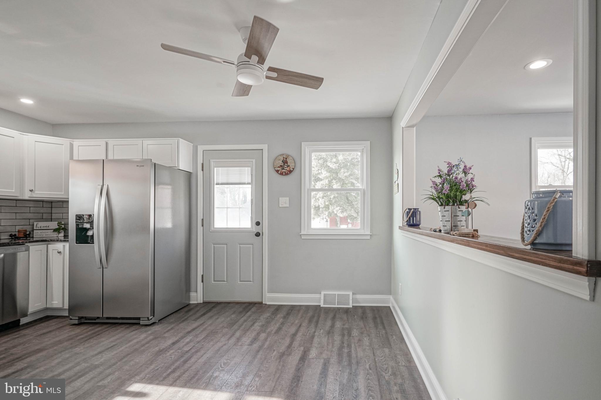 8 Riviera Drive Pennsville, NJ 08070 - Photo 9 of 31 a view of a kitchen from a windows a ceiling fan and wooden floor