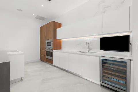 a utility room with cabinets dryer and washer