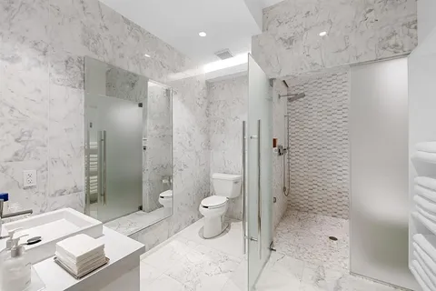 a bathroom with a bathtub sink and mirror