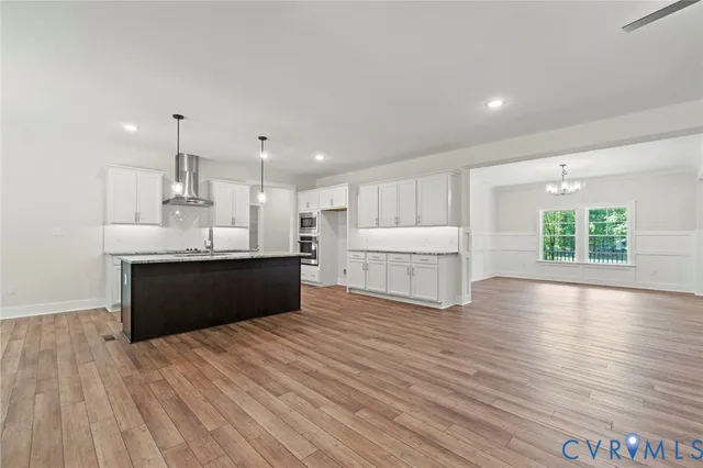 a kitchen with kitchen island white cabinets and white appliances