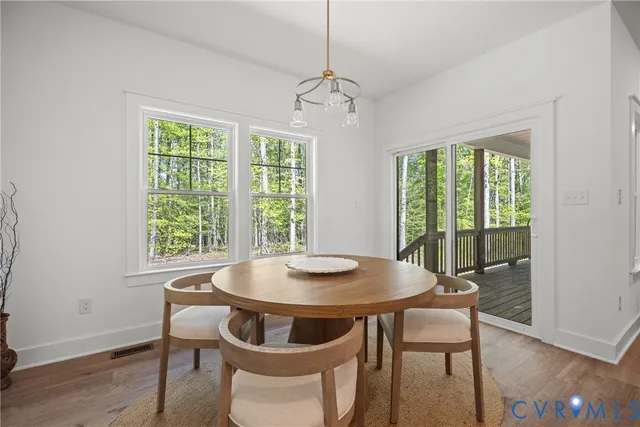 a large kitchen with stainless steel appliances granite countertop a large counter top and a wooden floors