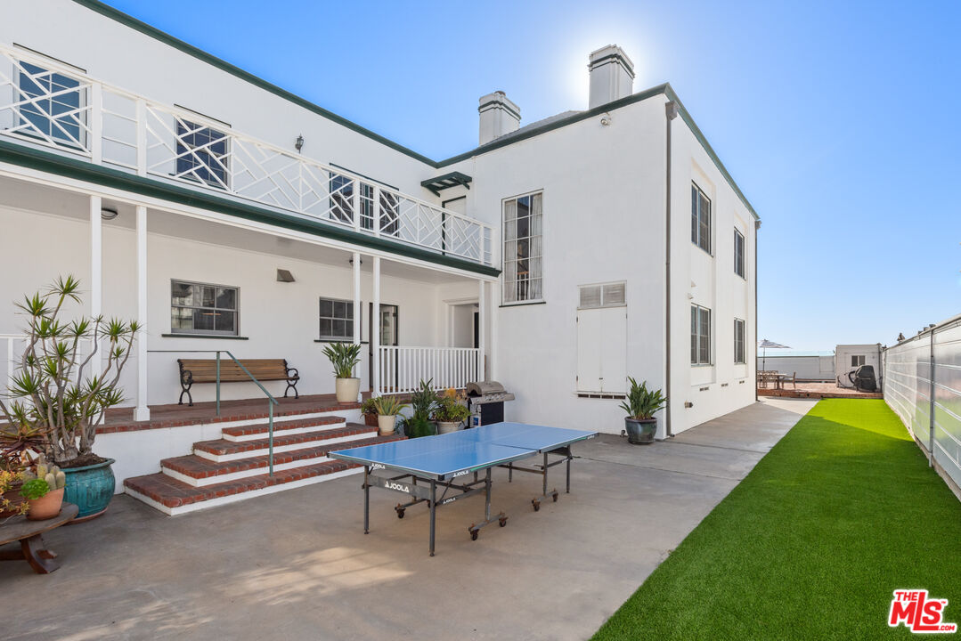 605 Palisades Beach Road Santa Monica, CA 90402 - Photo 11 of 33 a roof deck with table and chairs and potted plants