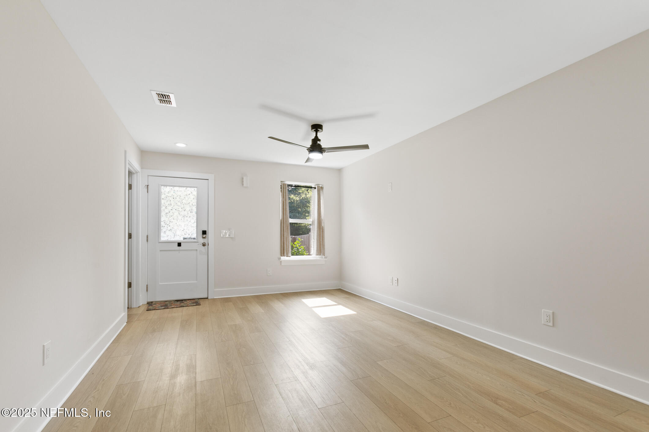 16 Sidney Street St. Augustine, FL 32084 - Photo 11 of 38 an empty room with wooden floor and windows