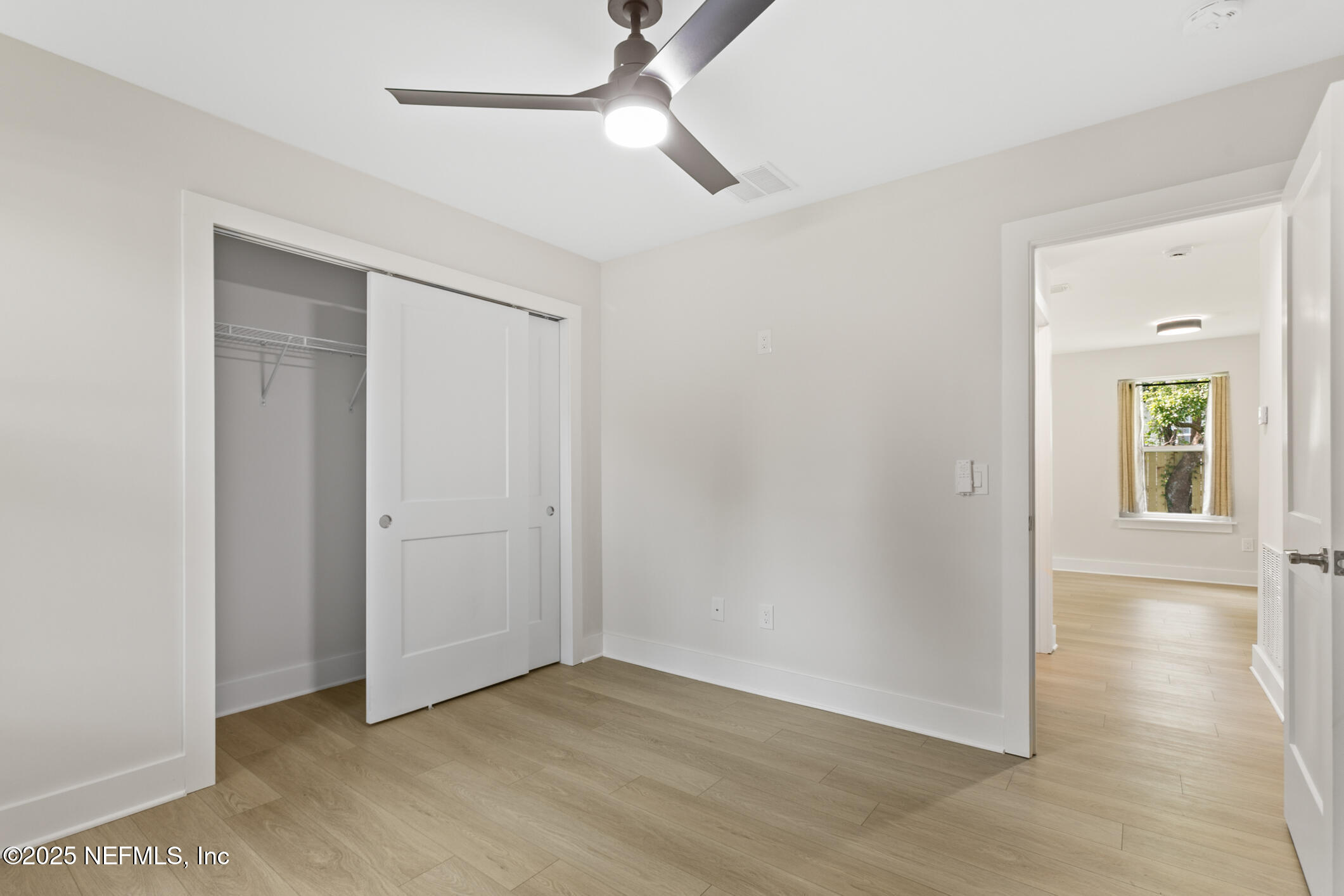 16 Sidney Street St. Augustine, FL 32084 - Photo 24 of 38 an empty room with wooden floor closet and windows
