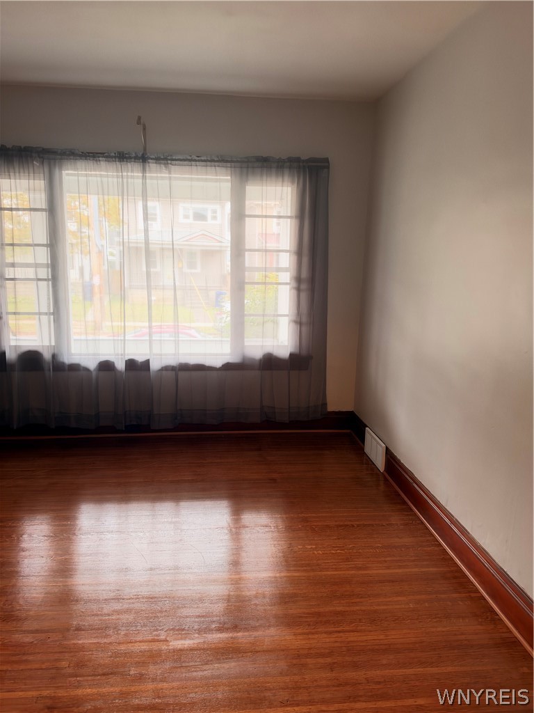 166 Herkimer Street Buffalo, NY 14213 - Photo 5 of 13 Rich wood paneling accents this room alongside a c