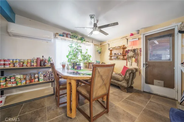 a dining room with furniture and a window