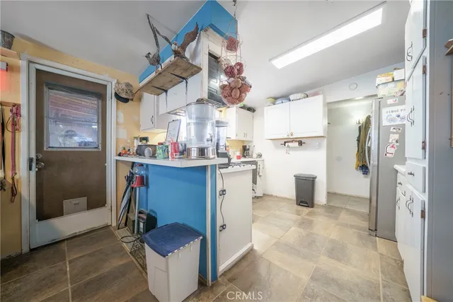 a kitchen with stainless steel appliances granite countertop a refrigerator and a stove