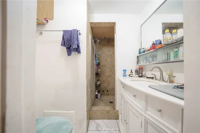 a bathroom with a sink vanity and mirror