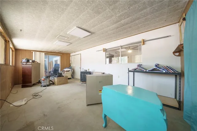a living room with furniture a window and kitchen view