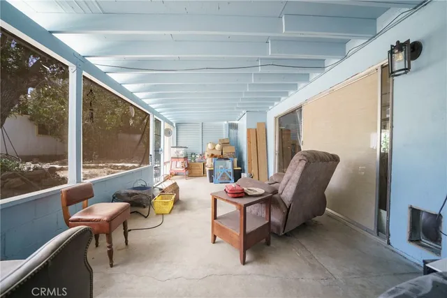 a living room with furniture and a floor to ceiling window