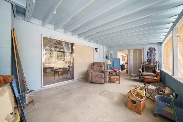 a living room with furniture gym equipment and a large window