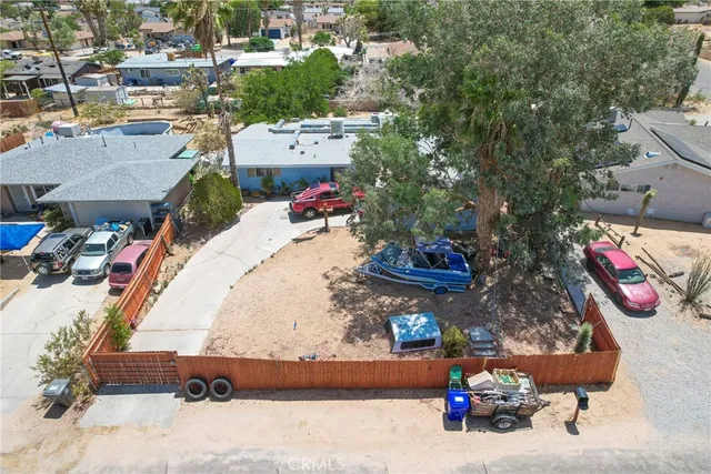 an aerial view of a house with a yard and sitting area