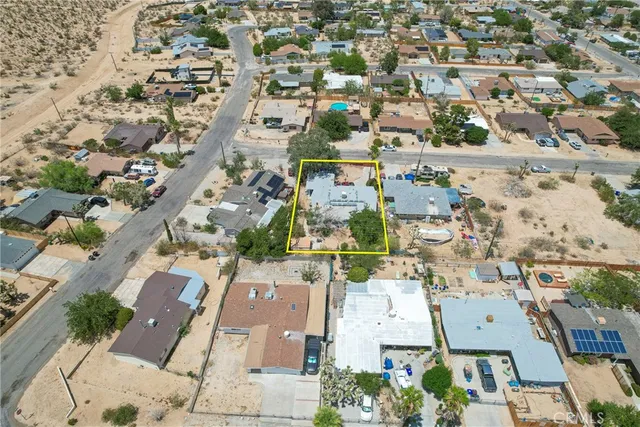 an aerial view of residential houses with outdoor space