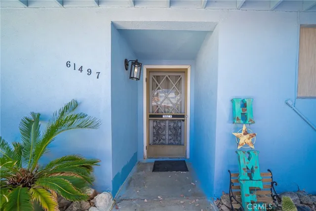 a hallway with painting and a potted plant