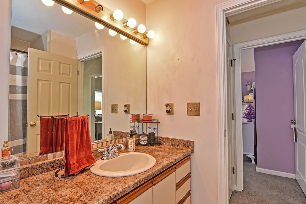 96 Danforth Street, Unit 19 Taunton, MA 02780 - Photo 20 of 31 a bathroom with a granite countertop sink and a mirror