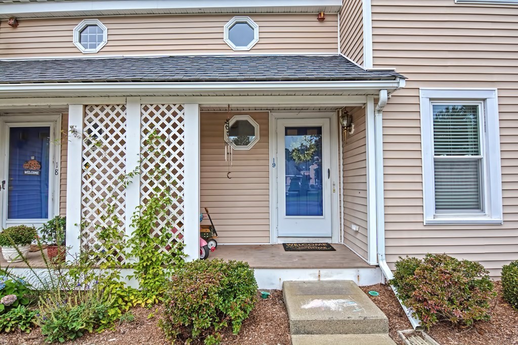 96 Danforth Street, Unit 19 Taunton, MA 02780 - Photo 2 of 31 a front view of a house with a garden