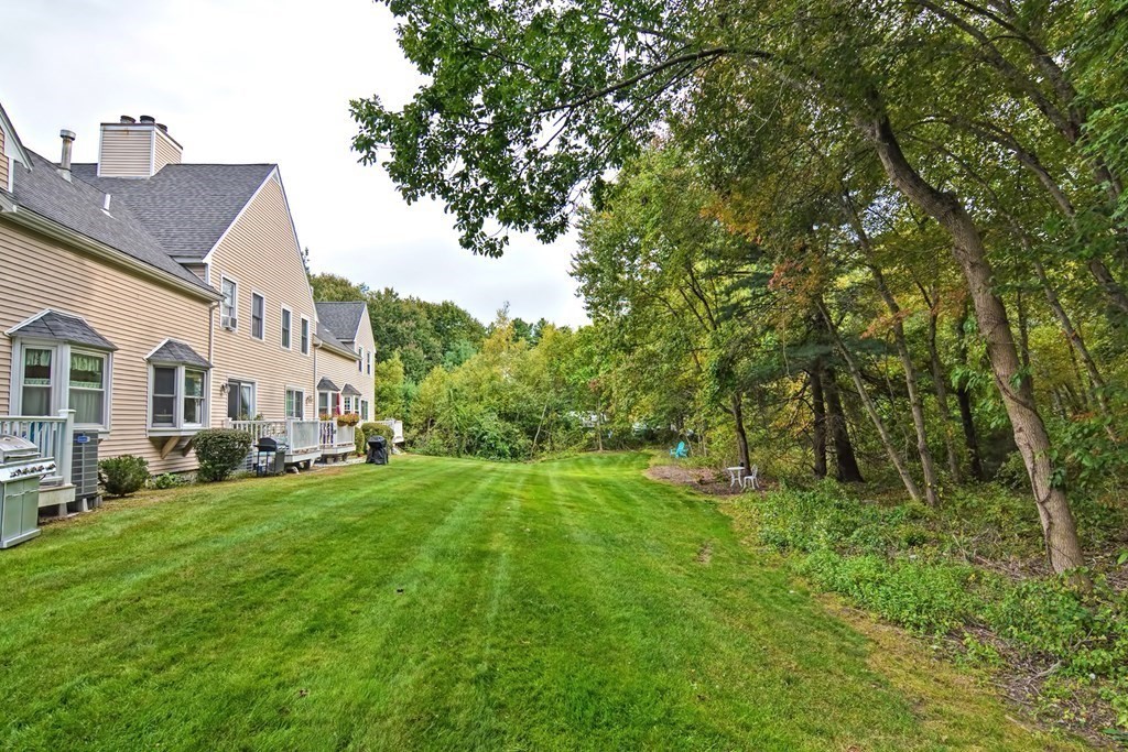 96 Danforth Street, Unit 19 Taunton, MA 02780 - Photo 26 of 31 a view of a house with a big yard and large trees