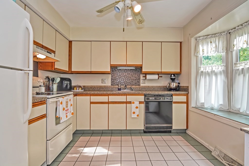 96 Danforth Street, Unit 19 Taunton, MA 02780 - Photo 8 of 31 a kitchen with stainless steel appliances granite countertop a stove a sink and a refrigerator