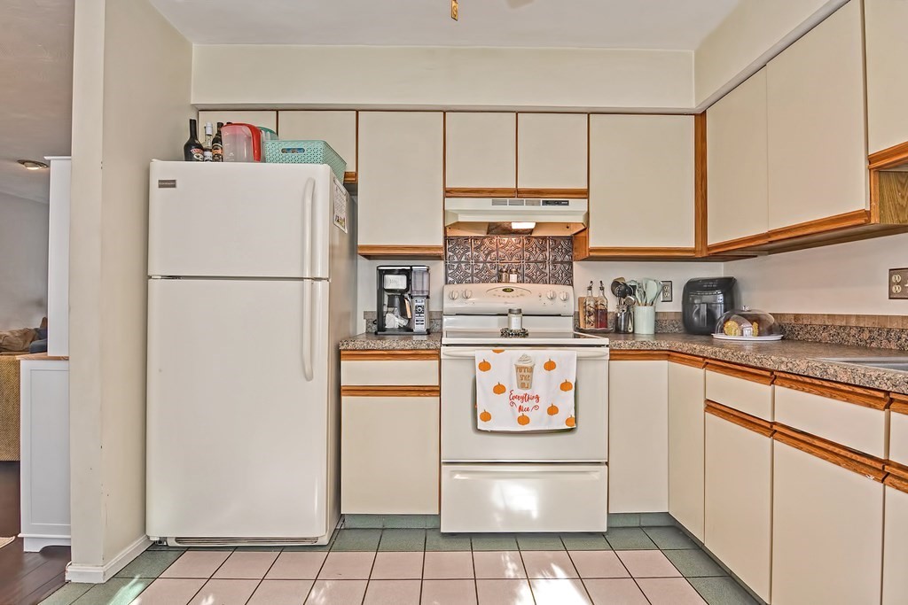 96 Danforth Street, Unit 19 Taunton, MA 02780 - Photo 9 of 31 a white refrigerator freezer sitting inside of a kitchen