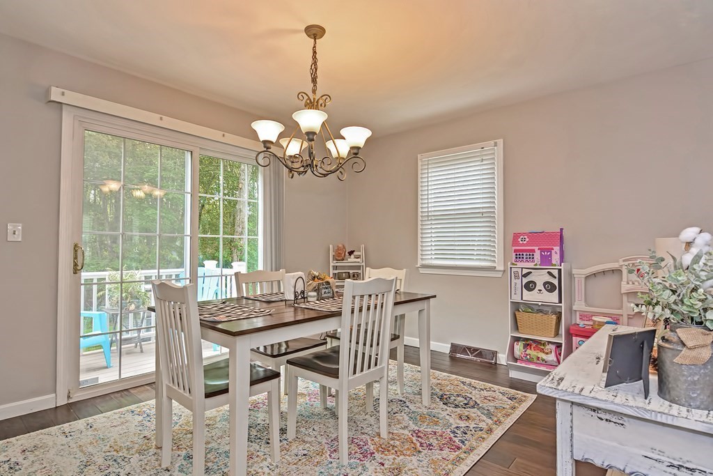 96 Danforth Street, Unit 19 Taunton, MA 02780 - Photo 10 of 31 a view of a dining room with furniture wooden floor and chandelier