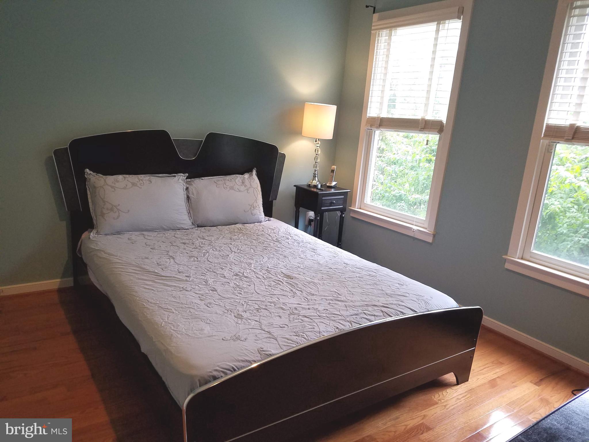 2338 Cobble Hill Terrace Silver Spring, MD 20902 - Photo 12 of 25 a bed sitting in a bedroom next to a window
