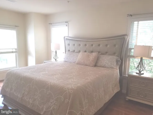 a view of a roof deck with table and chairs with wooden floor and fence