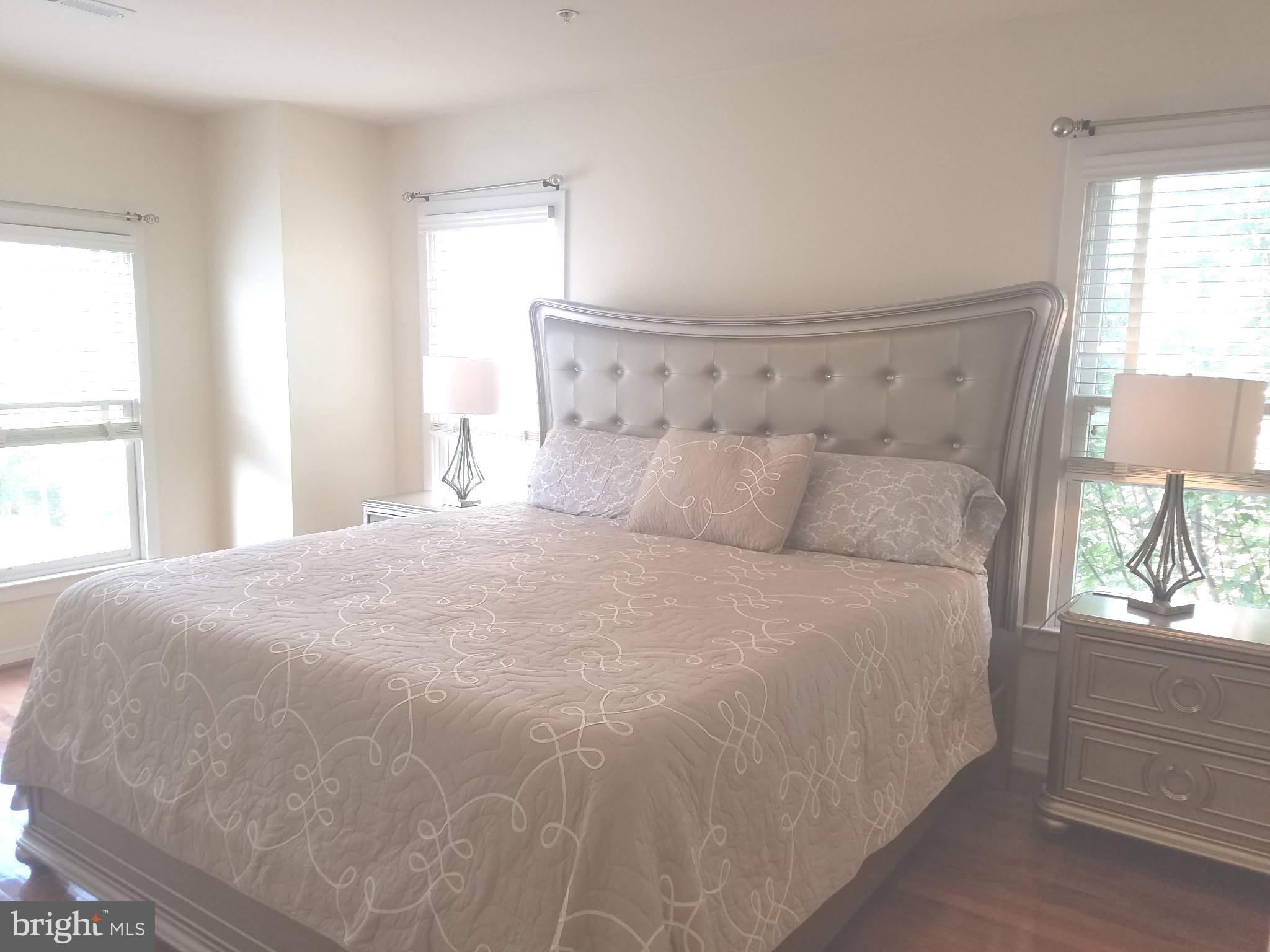 2338 Cobble Hill Terrace Silver Spring, MD 20902 - Photo 14 of 25 a large white bed in a bedroom next to a window