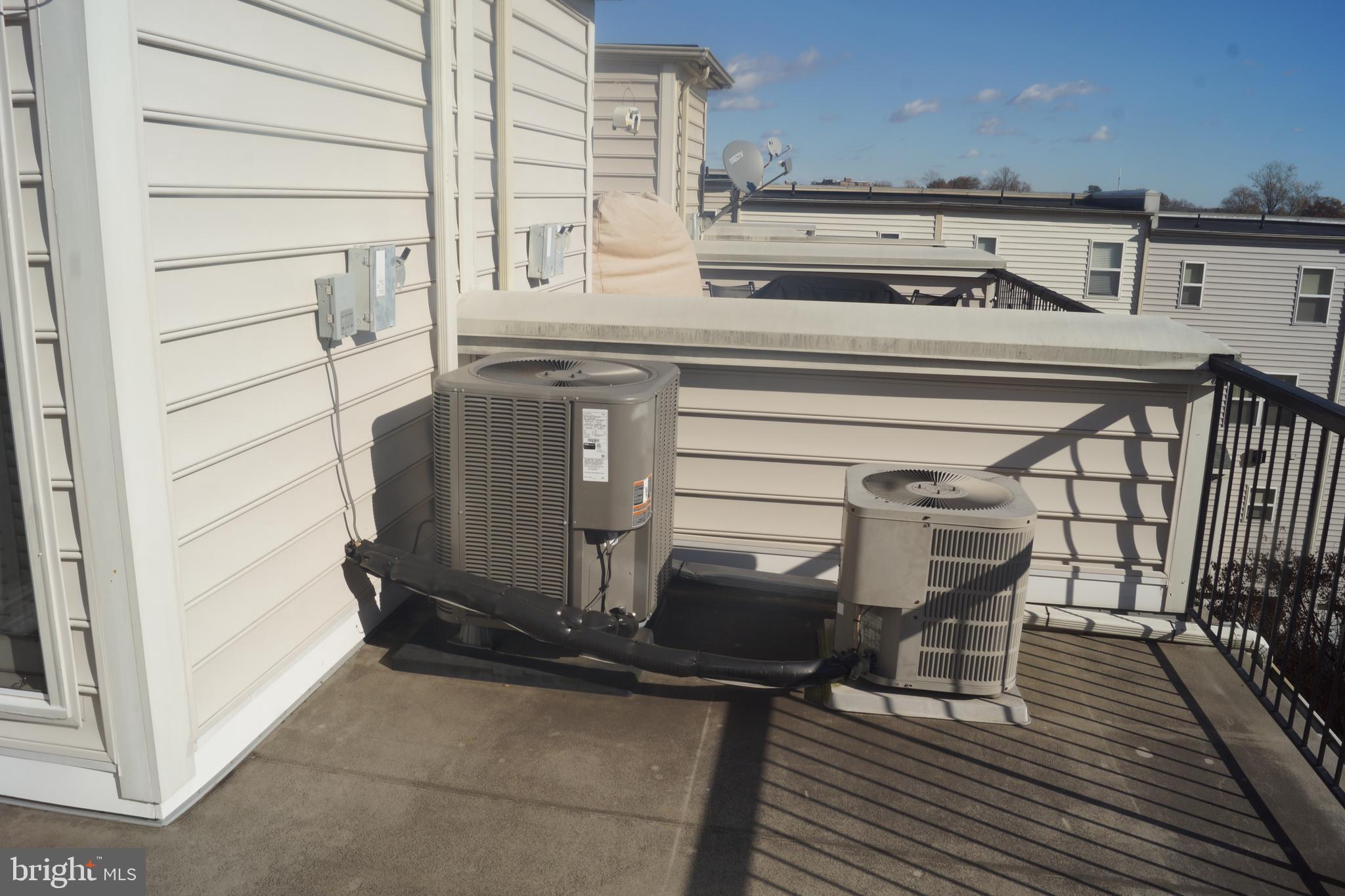2338 Cobble Hill Terrace Silver Spring, MD 20902 - Photo 15 of 25 a view of a roof deck with table and chairs with wooden floor and fence