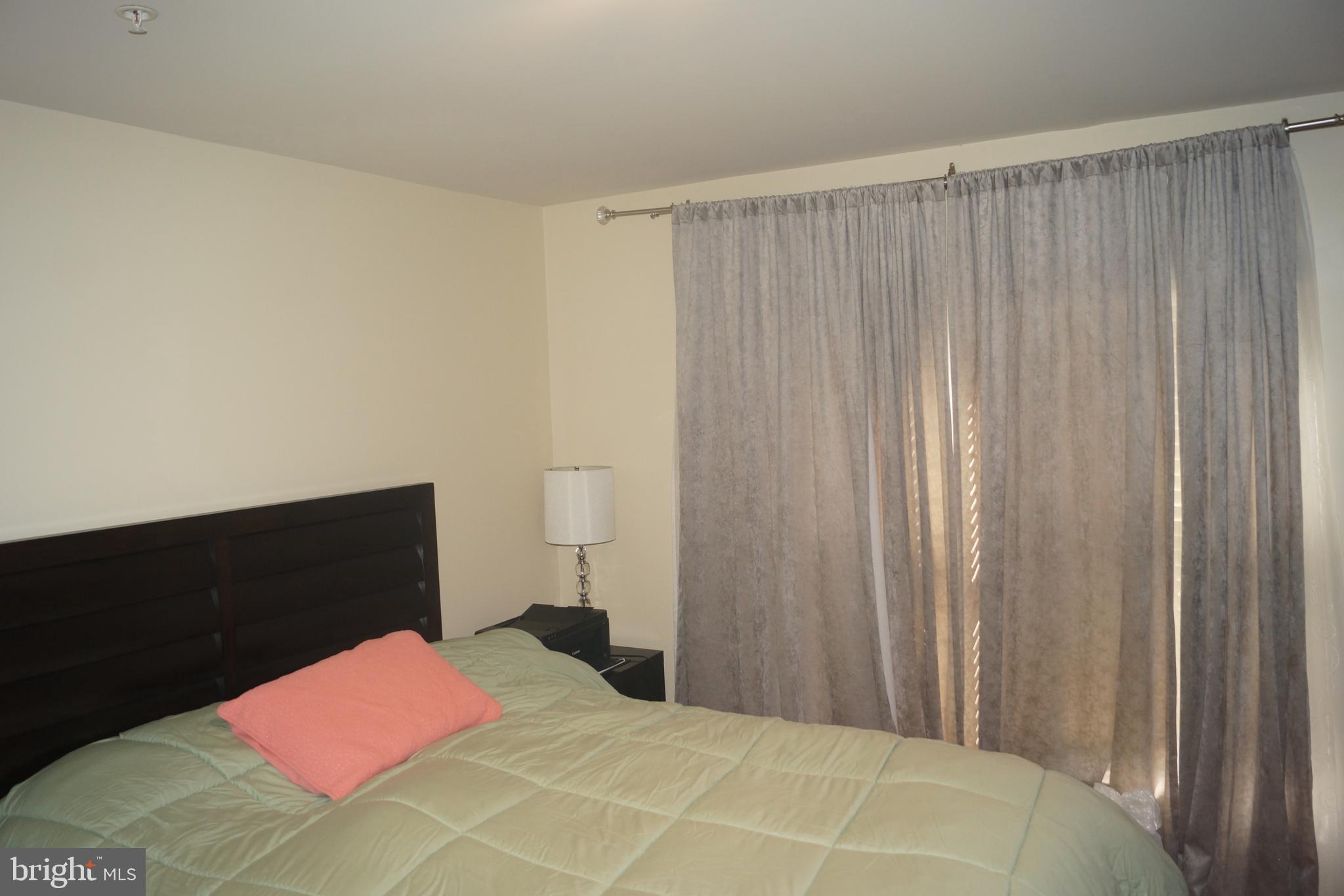 2338 Cobble Hill Terrace Silver Spring, MD 20902 - Photo 23 of 25 a bedroom with a bed and curtain