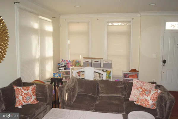a view of a bedroom with furniture and window