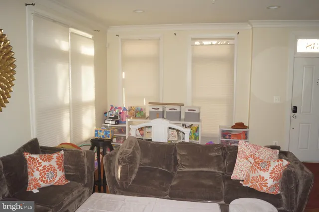 a view of a bedroom with furniture and window