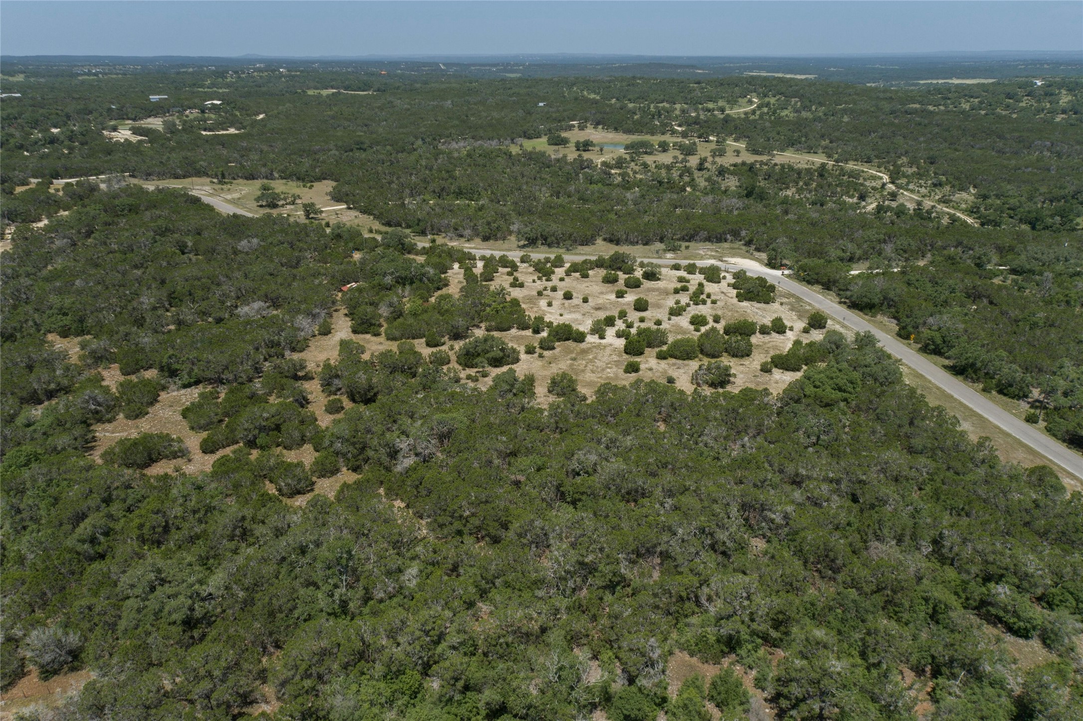 4401 Cottonwood Road Wimberley, TX 78676 - Photo 4 of 6 an aerial view of residential houses with outdoor space and trees