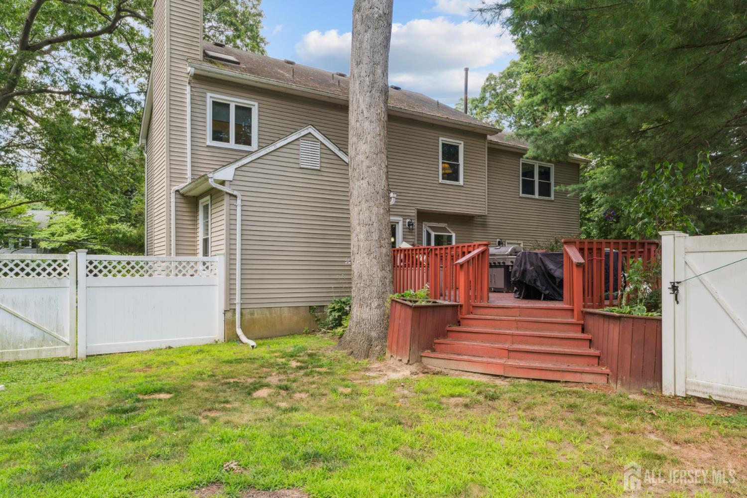 66 Spring Hill Road Old Bridge, NJ 07747 - Photo 12 of 32 a view of a house with backyard and wooden fence