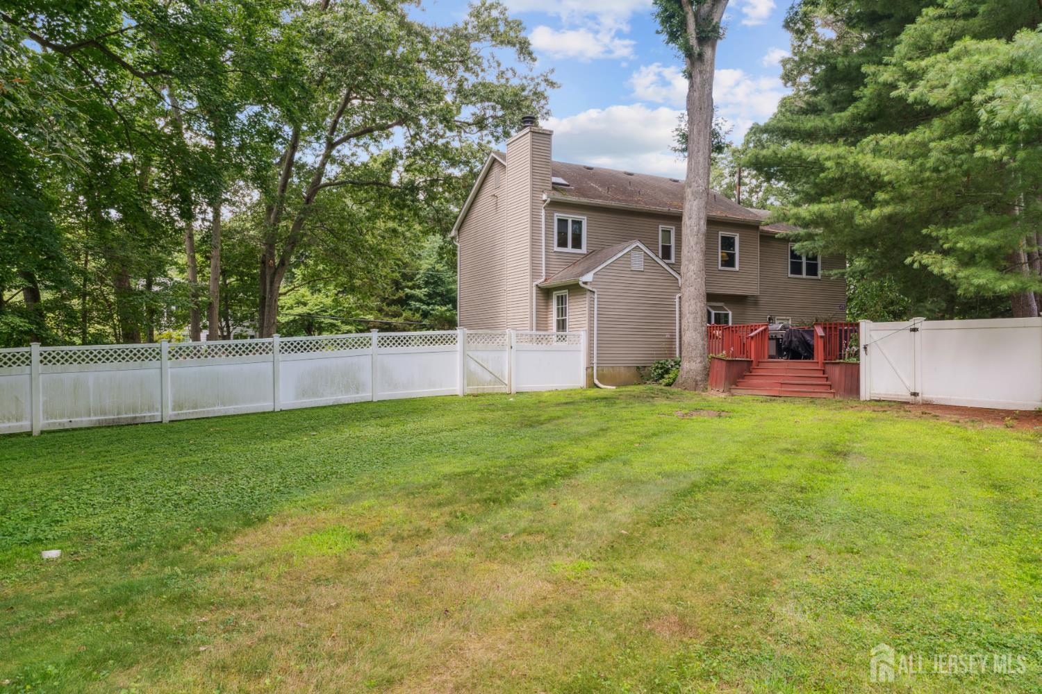 66 Spring Hill Road Old Bridge, NJ 07747 - Photo 13 of 32 a front view of a house with a yard and a tree