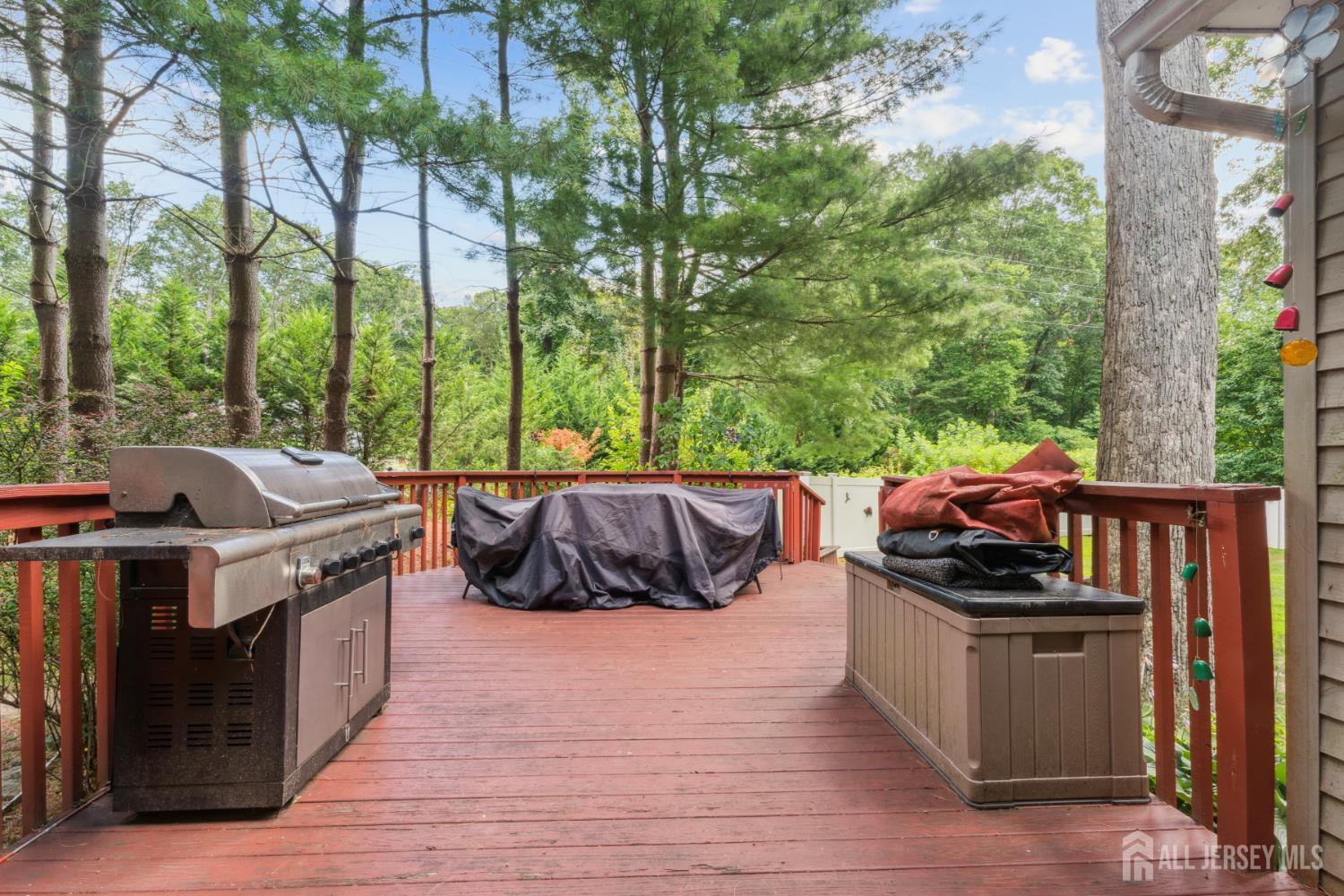 66 Spring Hill Road Old Bridge, NJ 07747 - Photo 14 of 32 a view of a patio with lawn chairs wooden floor and fence