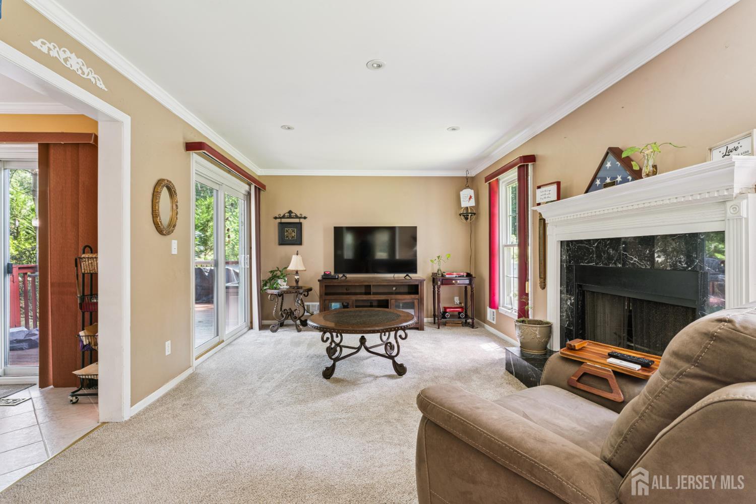 66 Spring Hill Road Old Bridge, NJ 07747 - Photo 19 of 32 a living room with furniture a flat screen tv and a fireplace