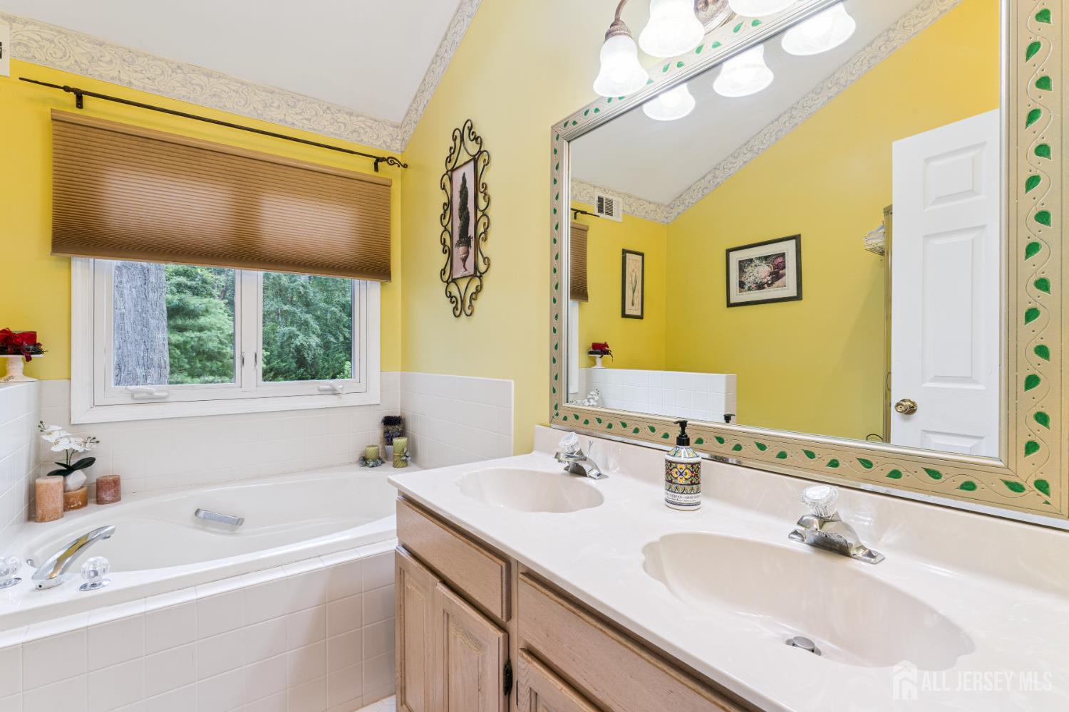 66 Spring Hill Road Old Bridge, NJ 07747 - Photo 23 of 32 a bathroom with a tub sink and mirror