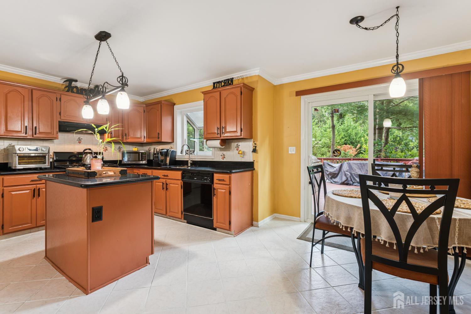 66 Spring Hill Road Old Bridge, NJ 07747 - Photo 5 of 32 a kitchen with stainless steel appliances granite countertop a stove top oven a sink dishwasher a dining table and chairs with wooden floor