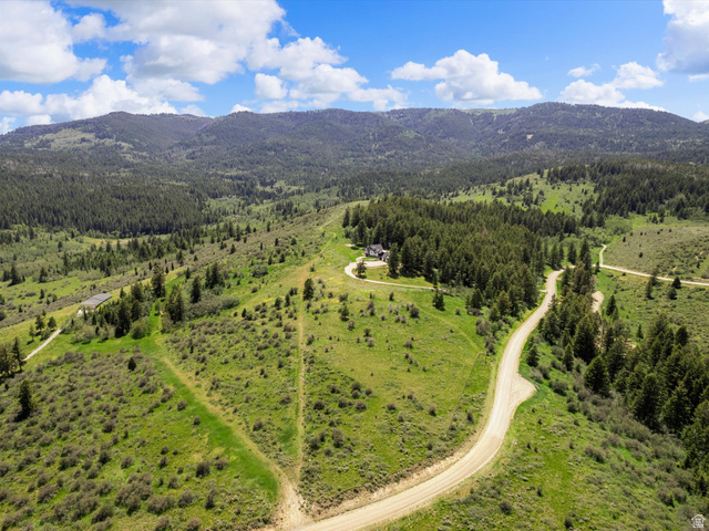 1225 Old Oregon Road Soda Springs, ID 83276 - Photo 62 of 67 Expansive property featuring a residence nestled among evergreen trees, surrounded by rolling hills and natural terrain