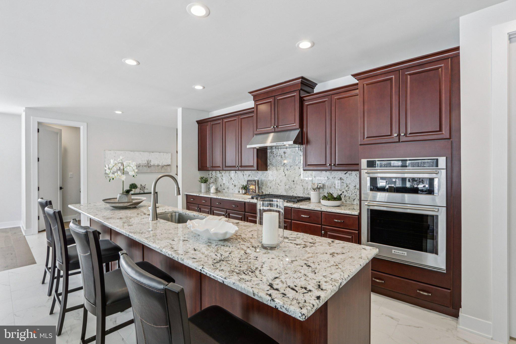 127 Alroy Road Malvern, PA 19355 - Photo 12 of 53 a kitchen with granite countertop kitchen island wooden cabinets and stainless steel appliances