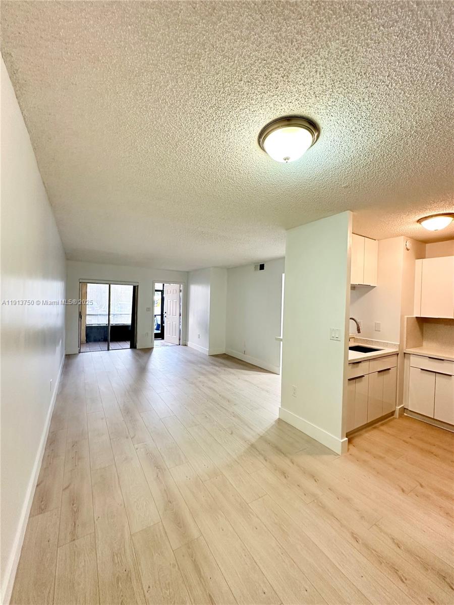 a view of a kitchen with a sink cabinets and a window